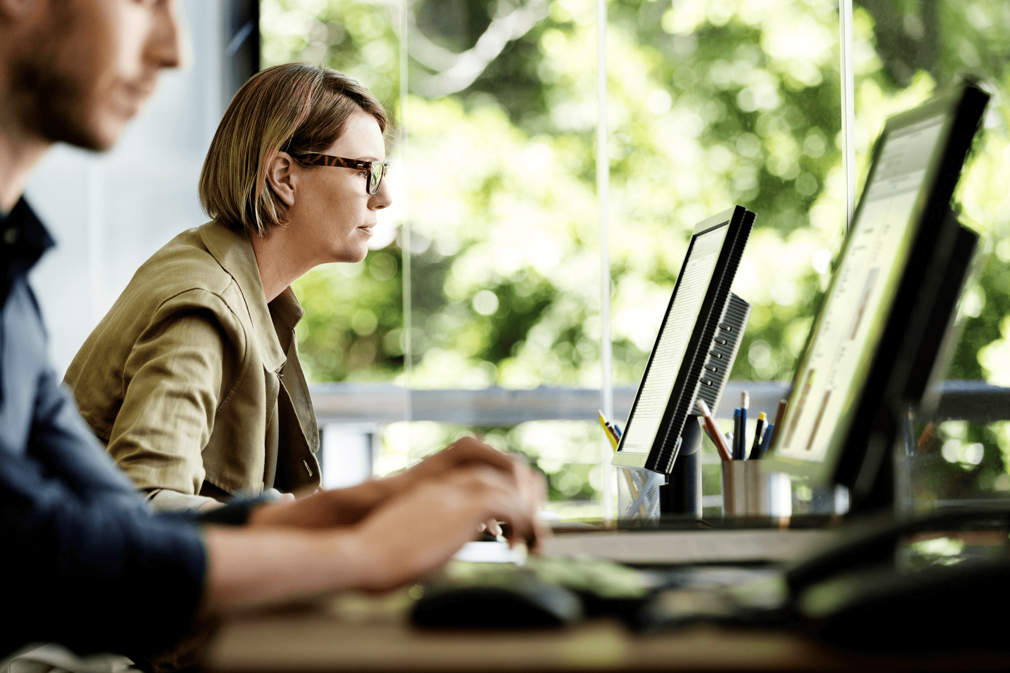A salesperson taking a customer request at their desk