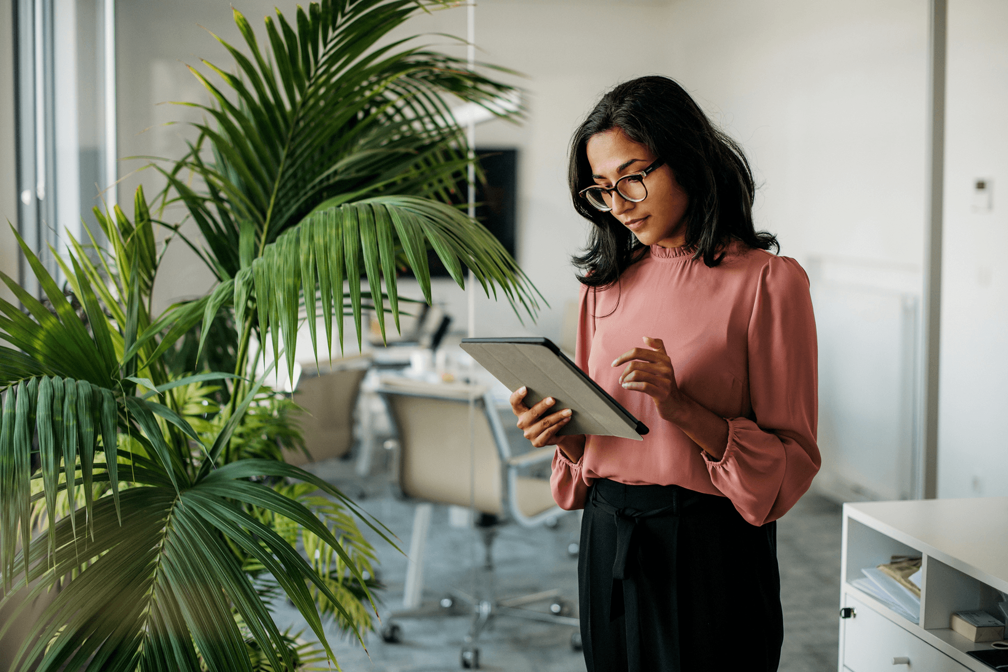 A finance professional reviewing figures on a tablet